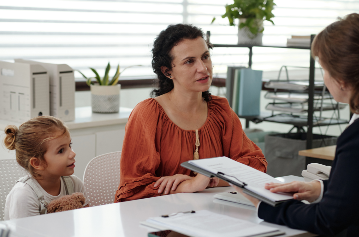 Community services worker consulting with family